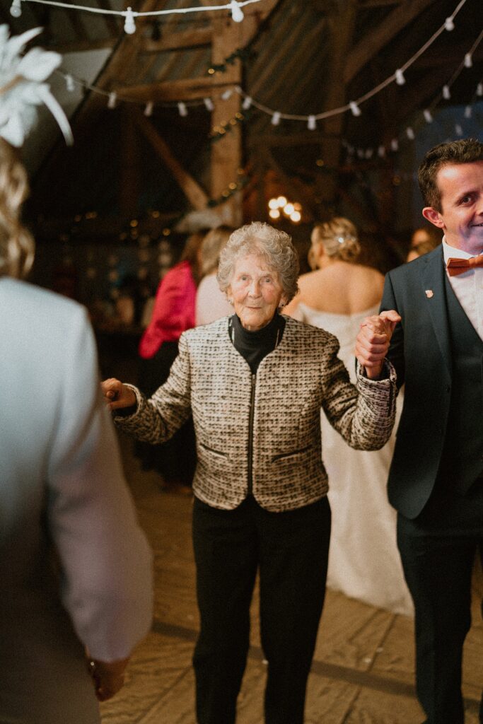 a grandmother dancing with wedding guests at a Ufton Court wedding