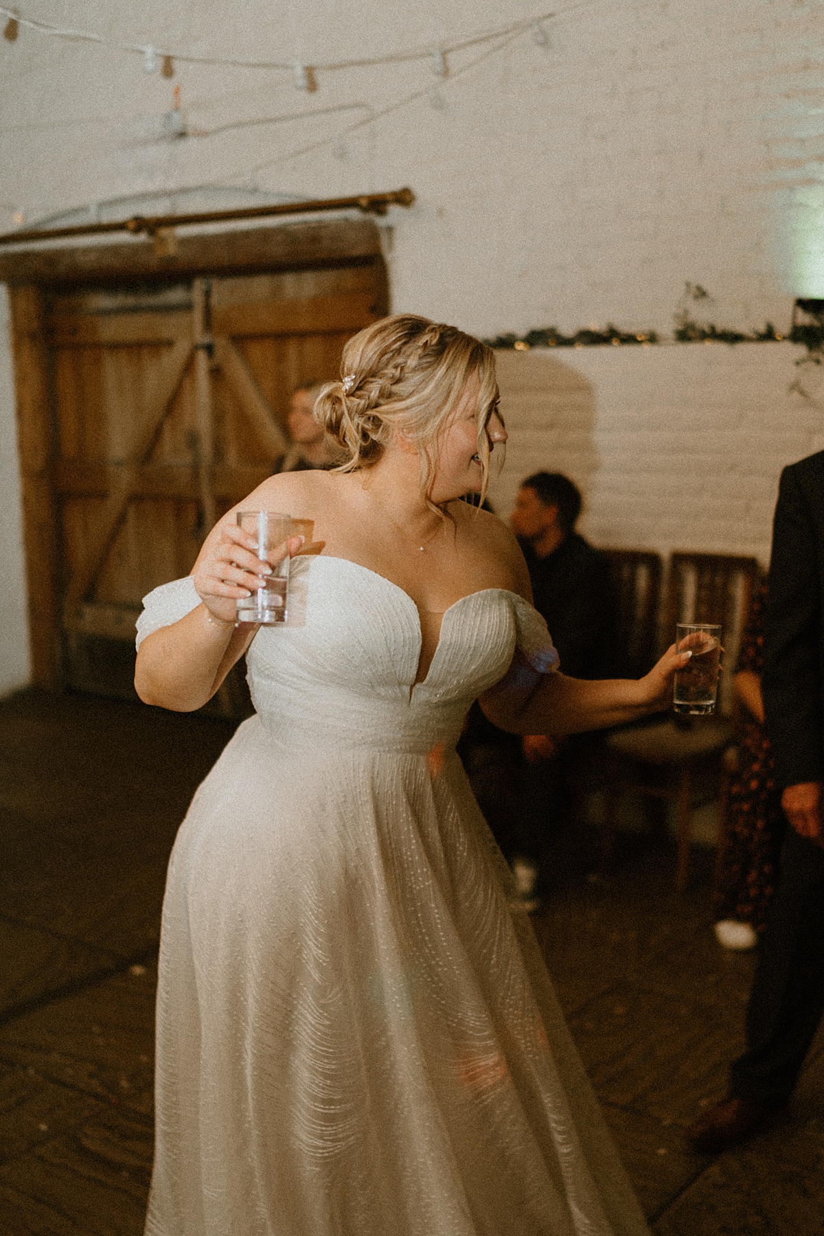 a bride dancing and singing at her wedding party at Ufton Court