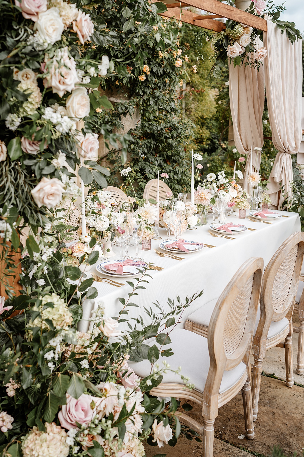 a floral table display including blush and cream flowers and lots of greenery at Euridge Manor in The Cotswolds