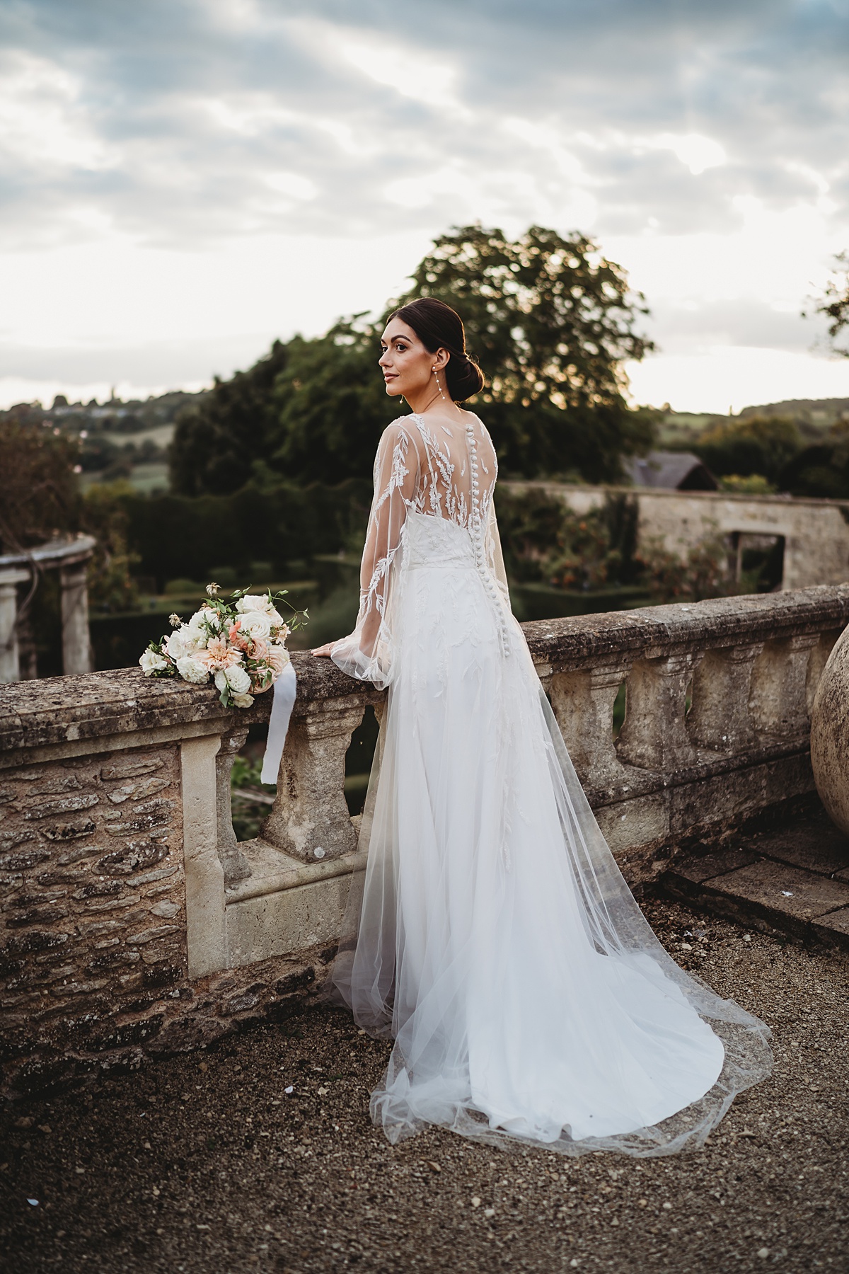 a bridal portrait of a bride looking out at the grounds of euridge manor