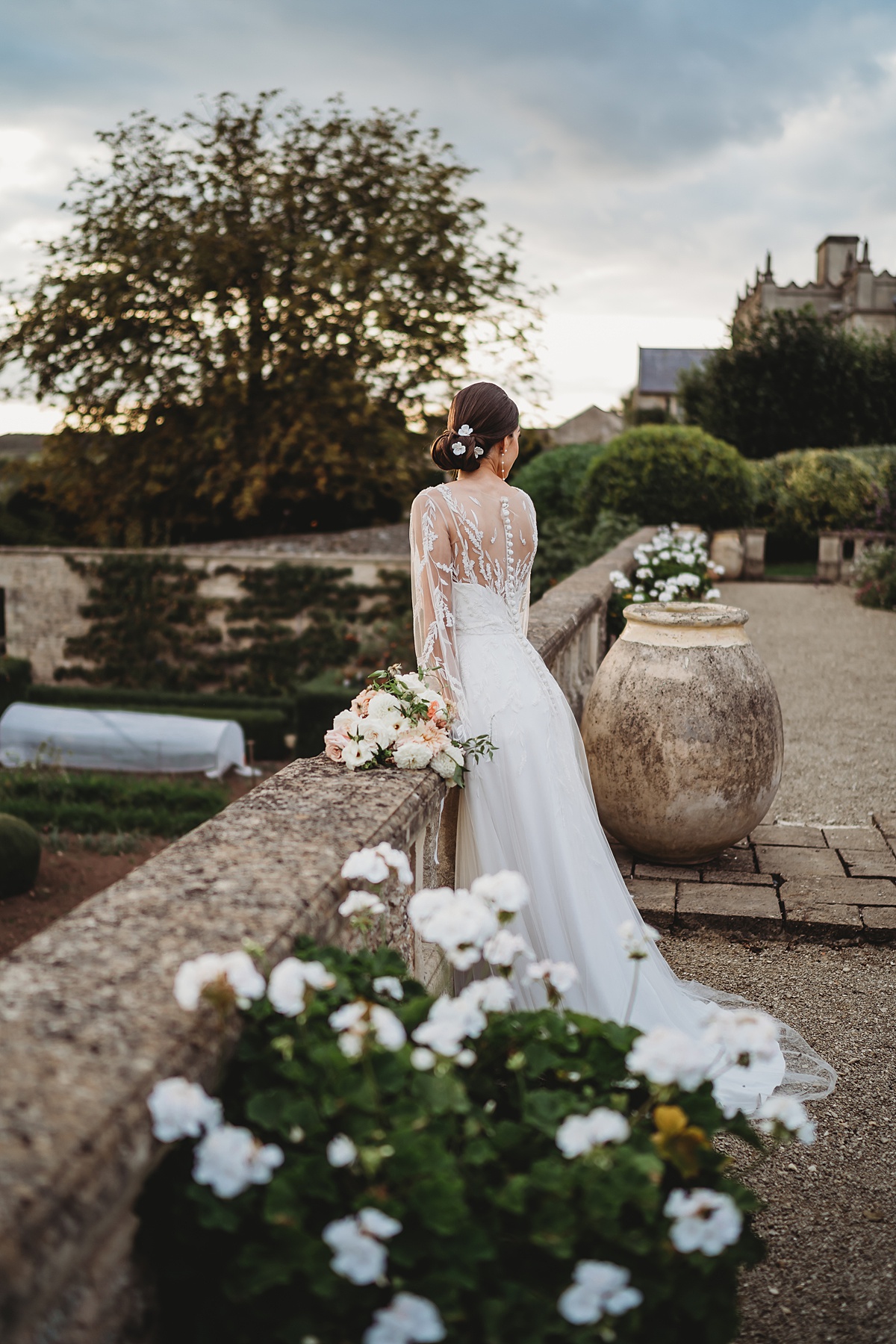 a bridal portrait of a bride looking out at the grounds of euridge manor