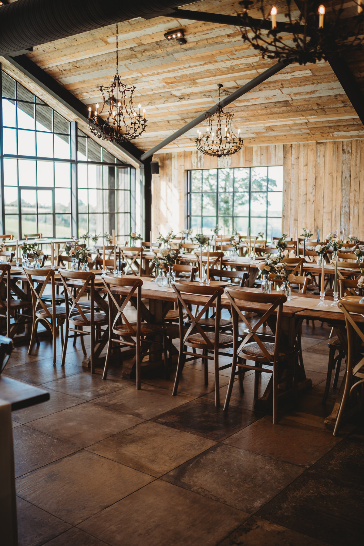 a luxury barn in Surrey ready and prepared for a wedding breakfast before the guests have arrived