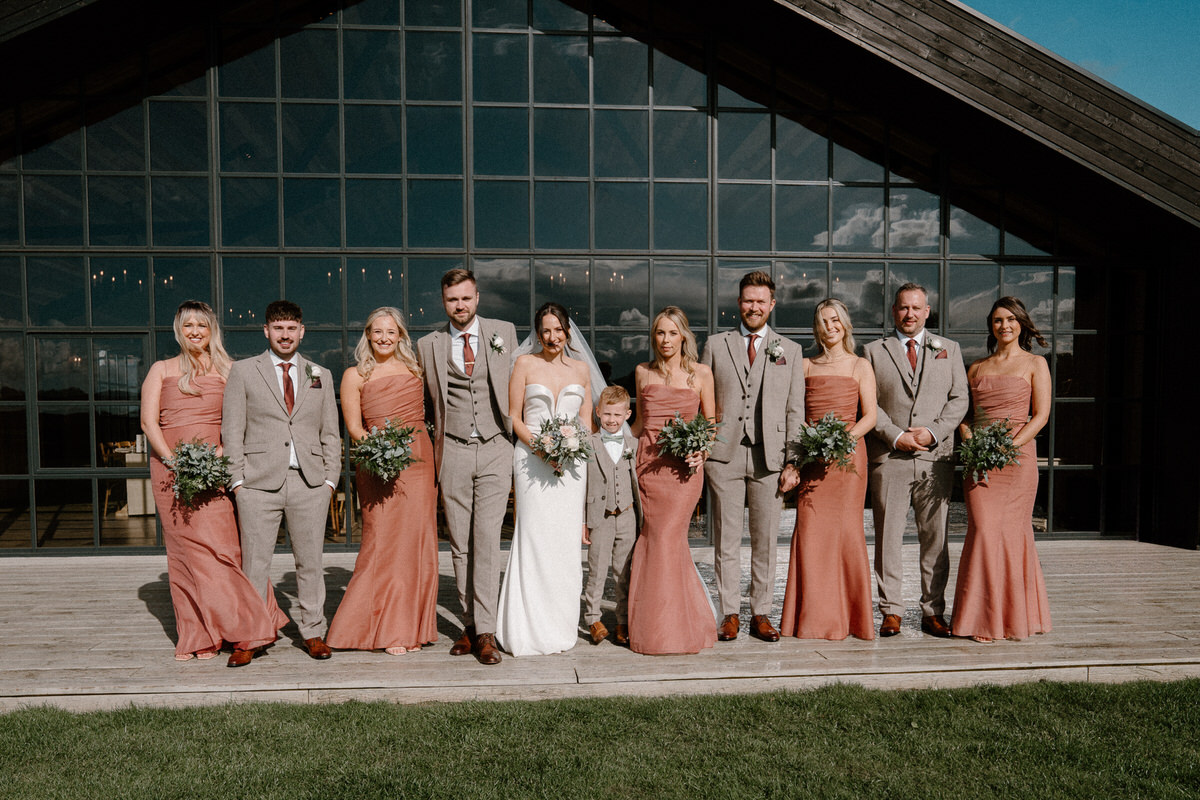 full wedding party lined up for wedding portraits for a surrey wedding photographer