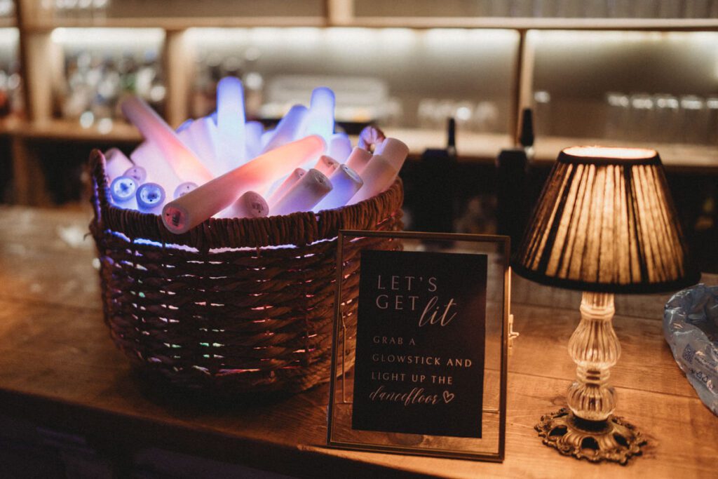 glow sticks lit up in a basket ready for a wedding reception party to start at Botley Hill Barn a Luxury Wedding Venue