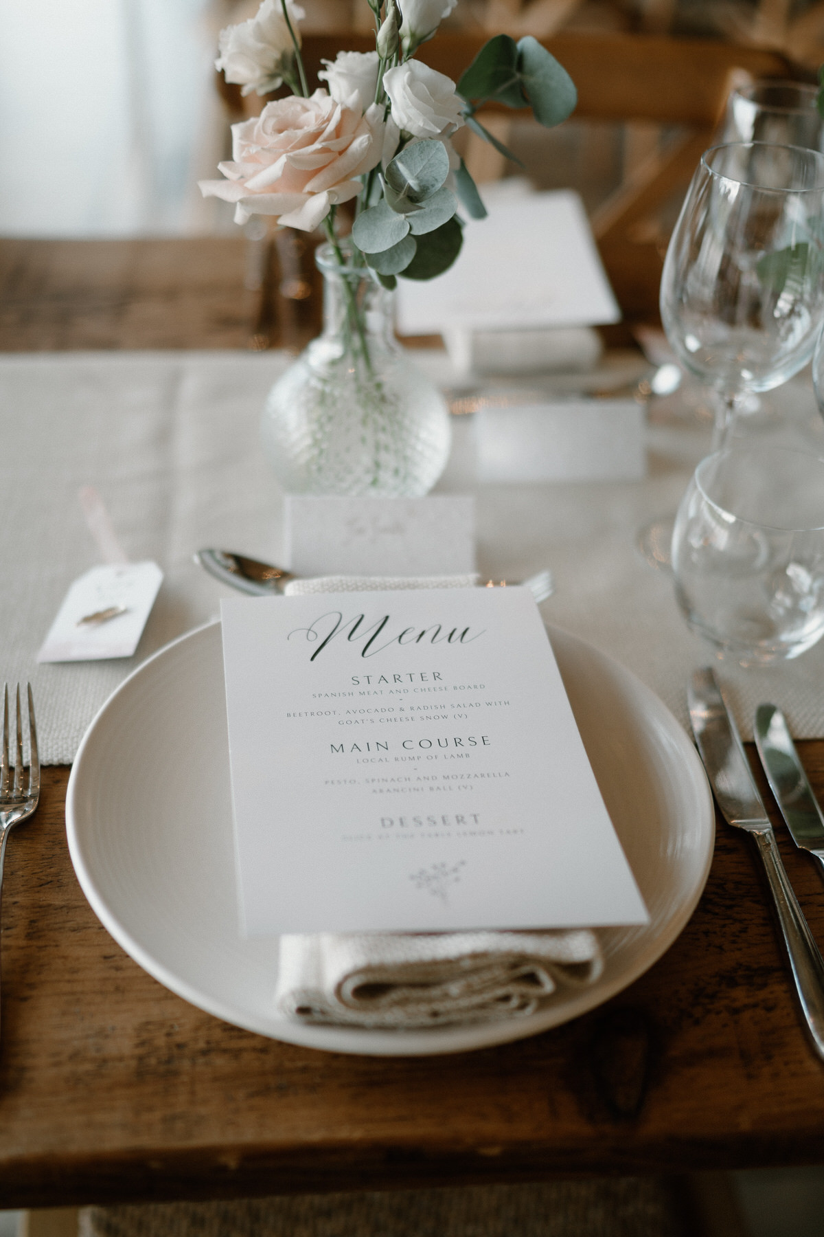 a cream themed table setting ready for a wedding breakfast