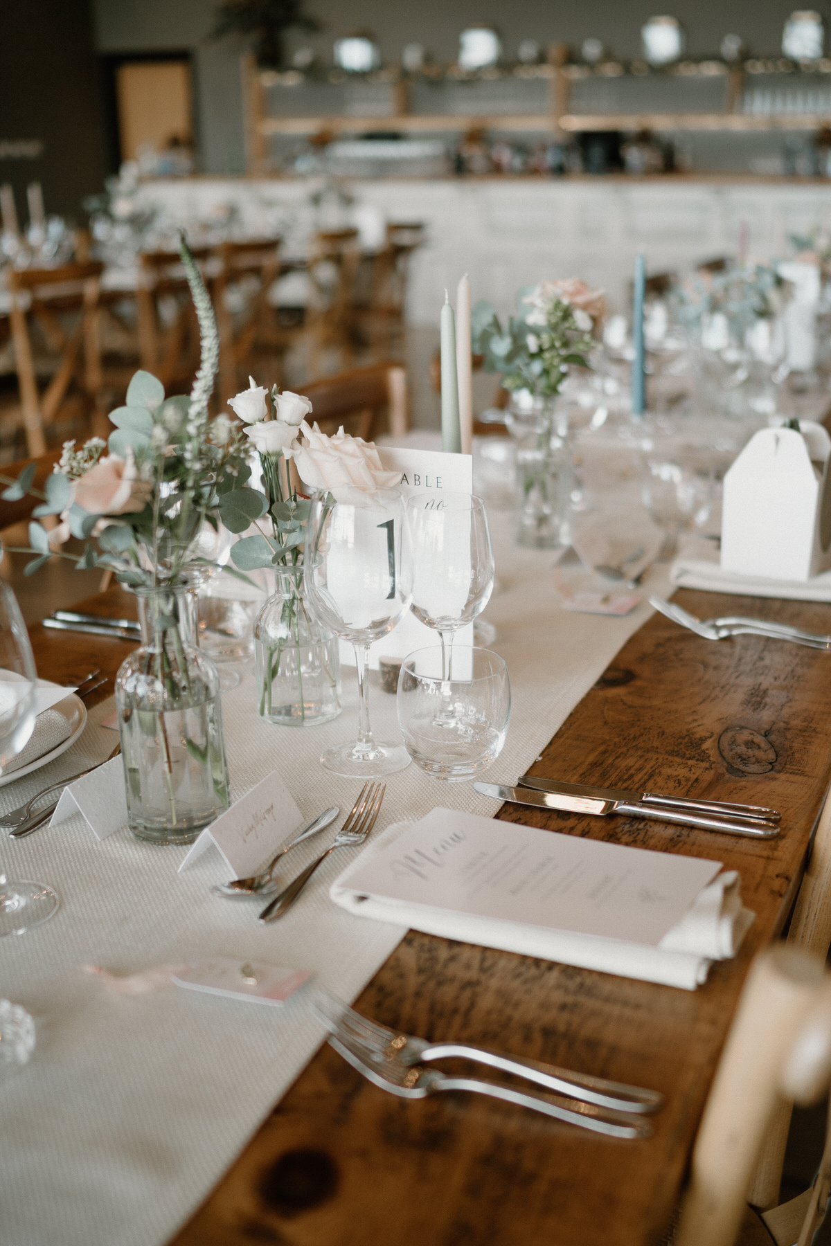 a cream, green and pink themed table setting ready for a wedding breakfast