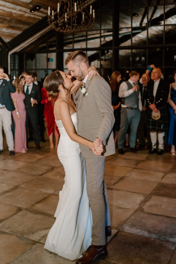 a bride and grooms first dance, they kiss and dance taken by a Botley Hill Barn Luxury Wedding Photographer