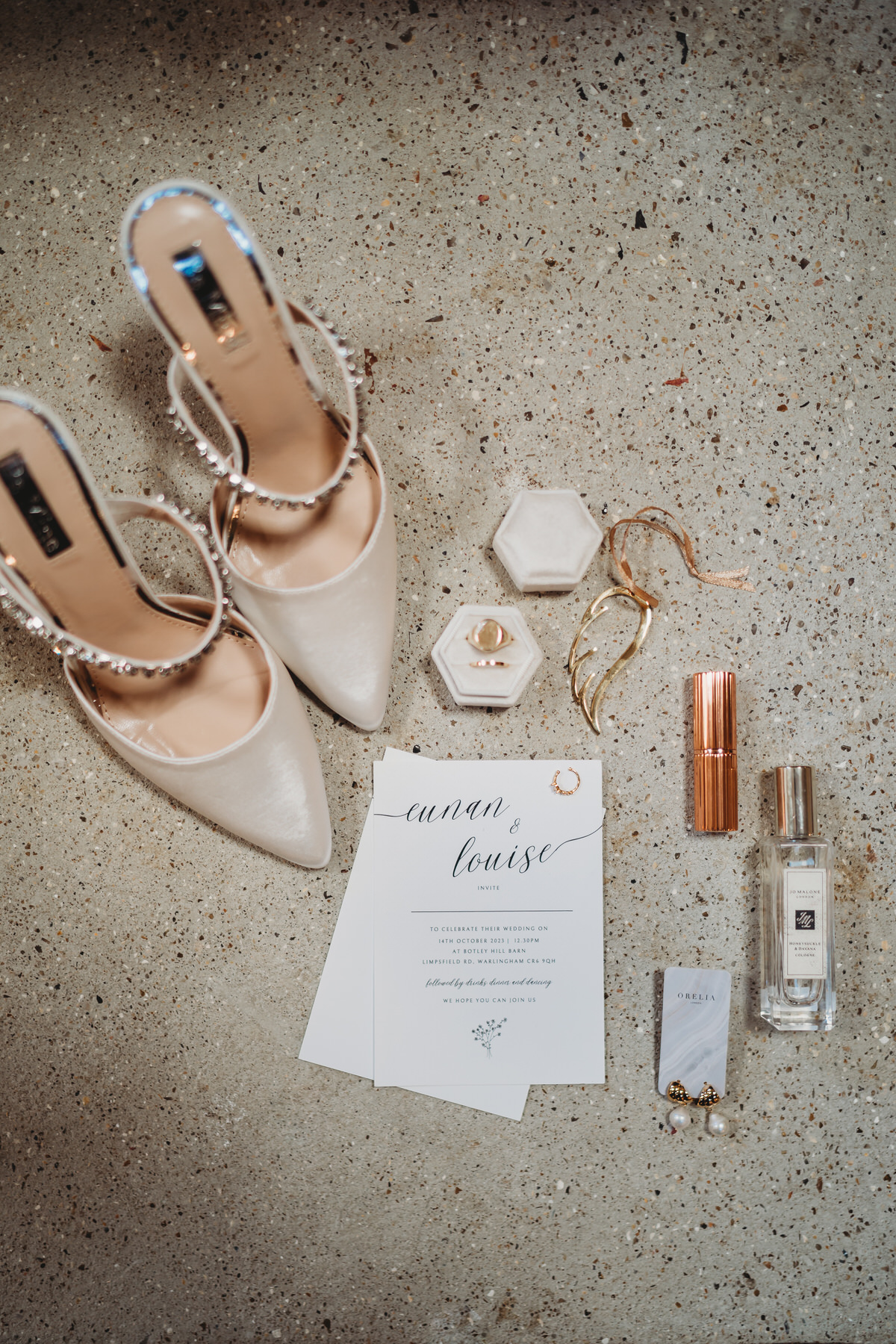 wedding details gathered together including shoes, invites and jewellery at Botley Hill Barn Surrey