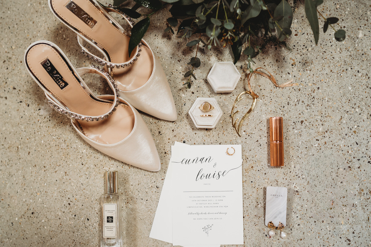 an aerial image of the smaller details of a wedding including shows, perfume and jewellery taken by Botley Hill Barn Luxury Wedding Photographer