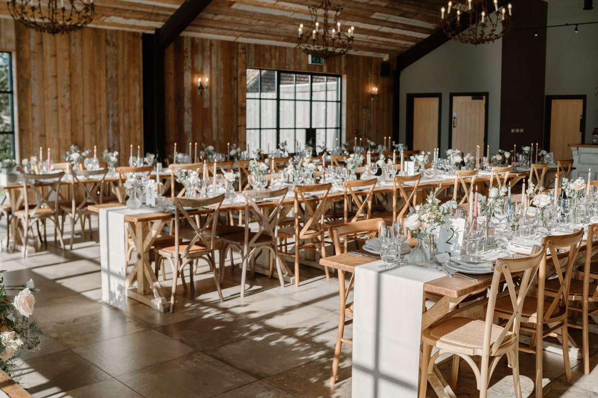 a cream themed table setting ready for a wedding breakfast