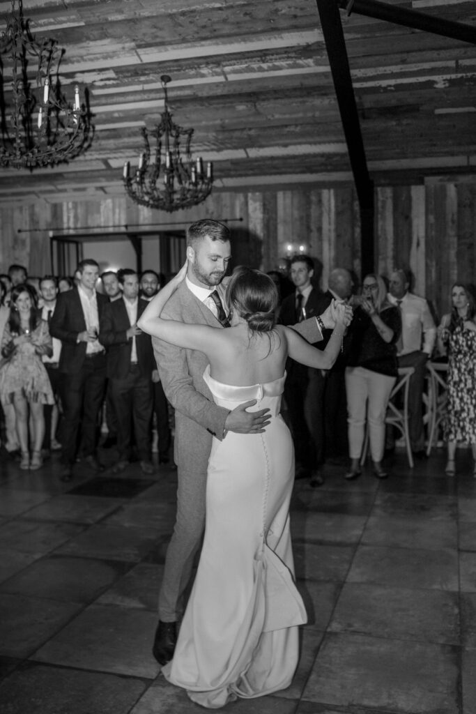 a bride and groom having their first dance at he Botley Hill Barn luxury wedding venue in Surrey