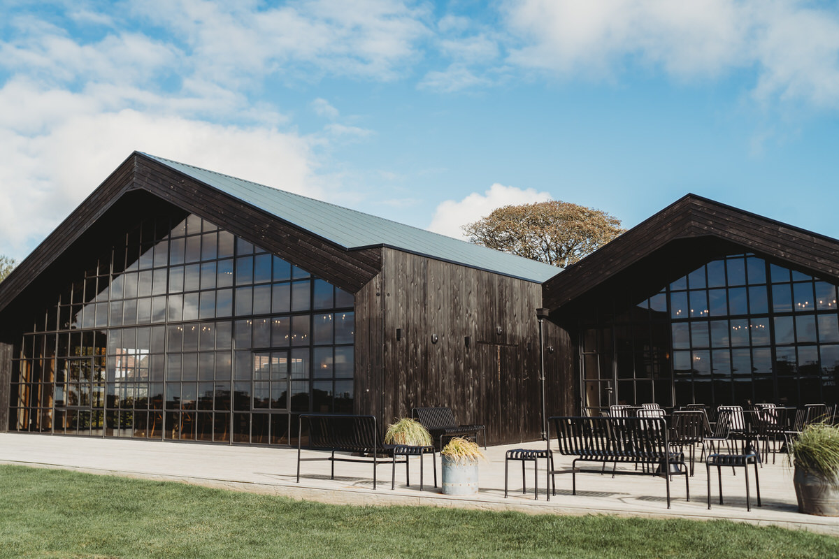 an outdoor image of botley hill barn wedding venue with blue dappled sky in the background