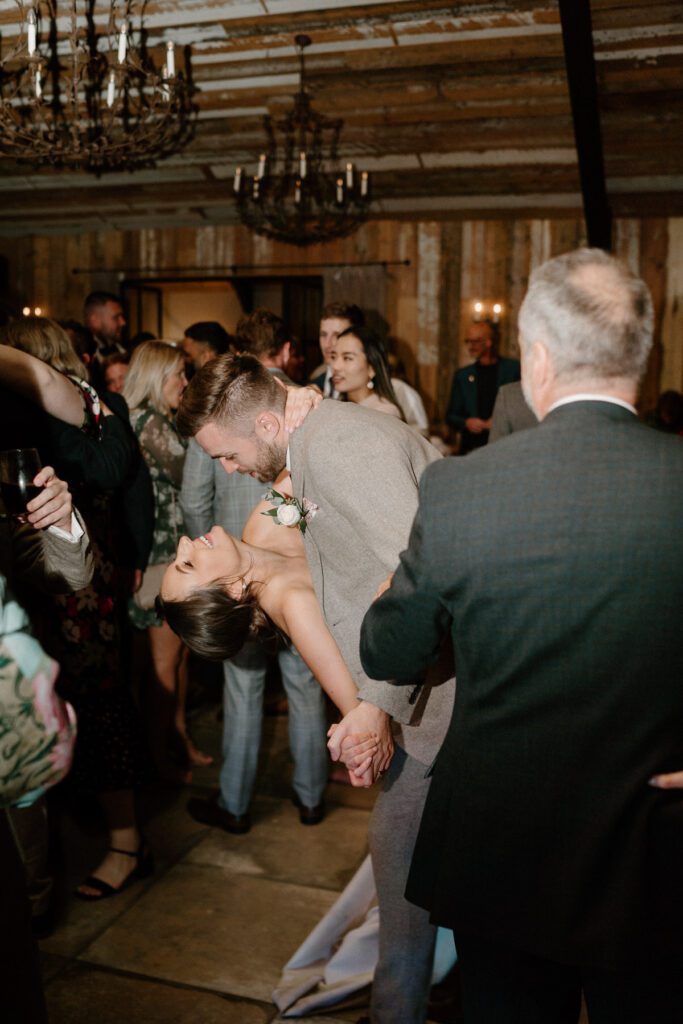 a groom dipping his bride back during their first dance at a Luxury wedding venue, the Botley Hill Barn