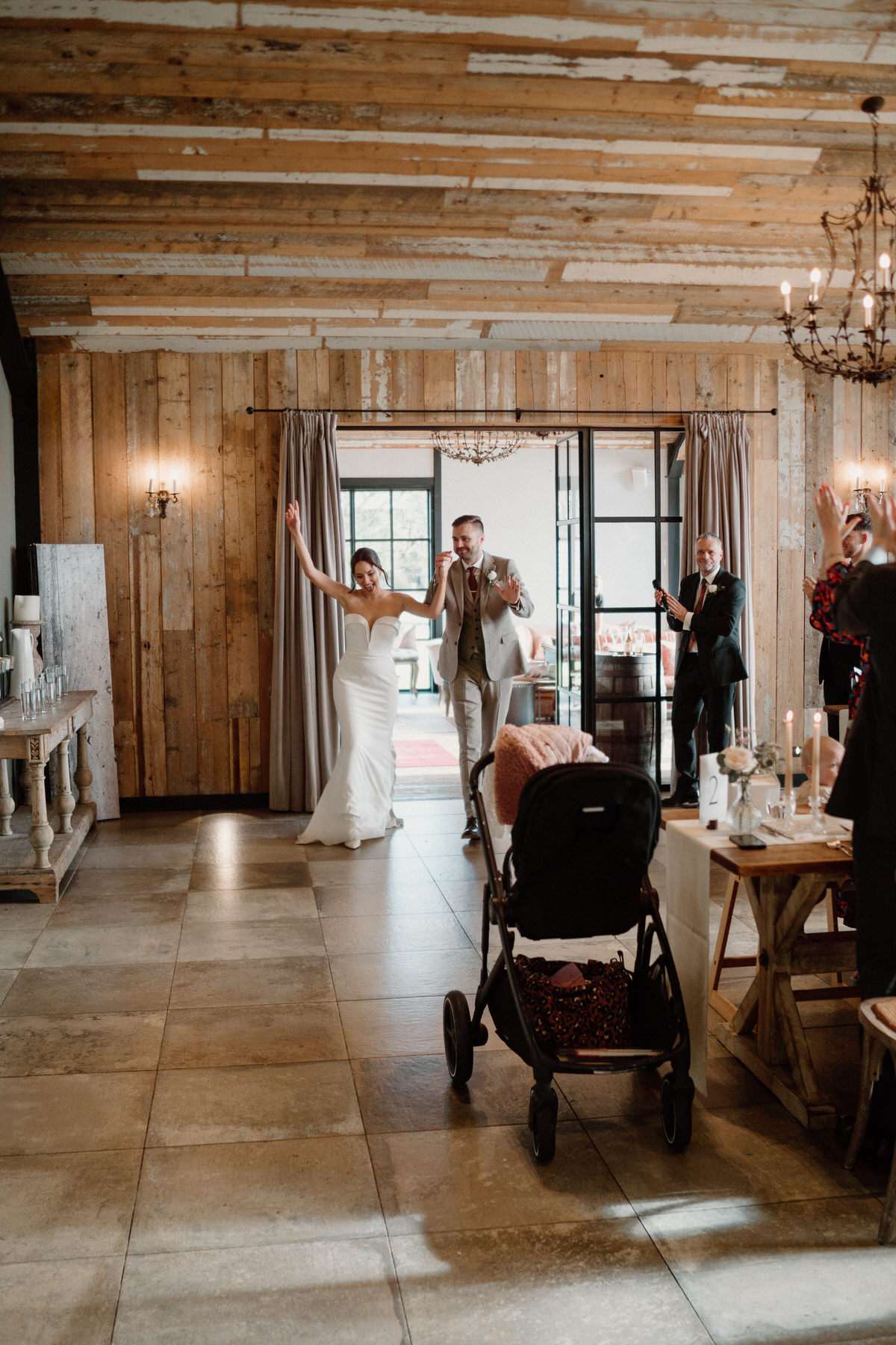 bride and groom enter their wedding breakfast dancing and singing at botley Hill Barn