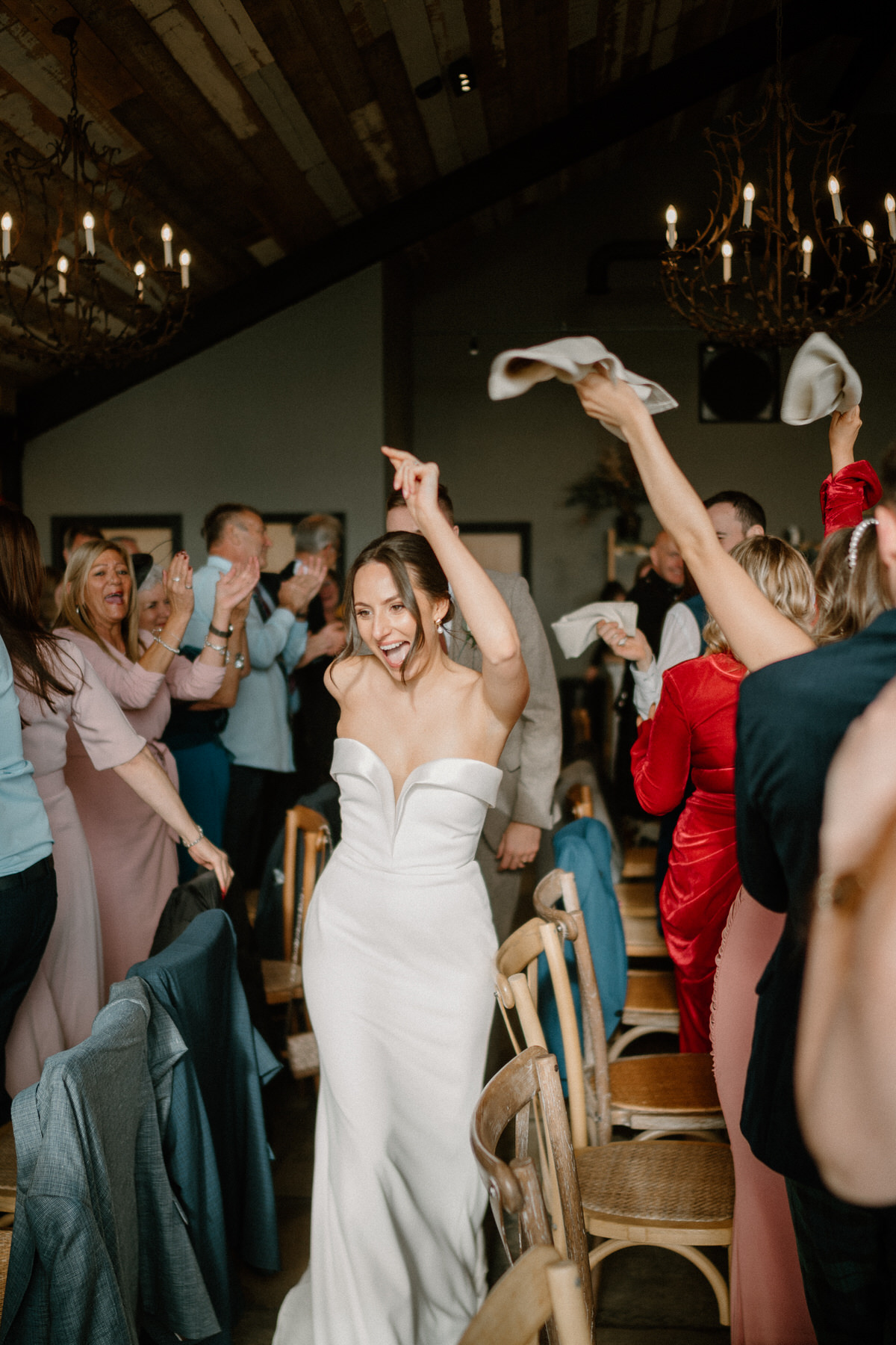 a bride singing and dancing as the enter their wedding breakfast at a surrey wedding venue