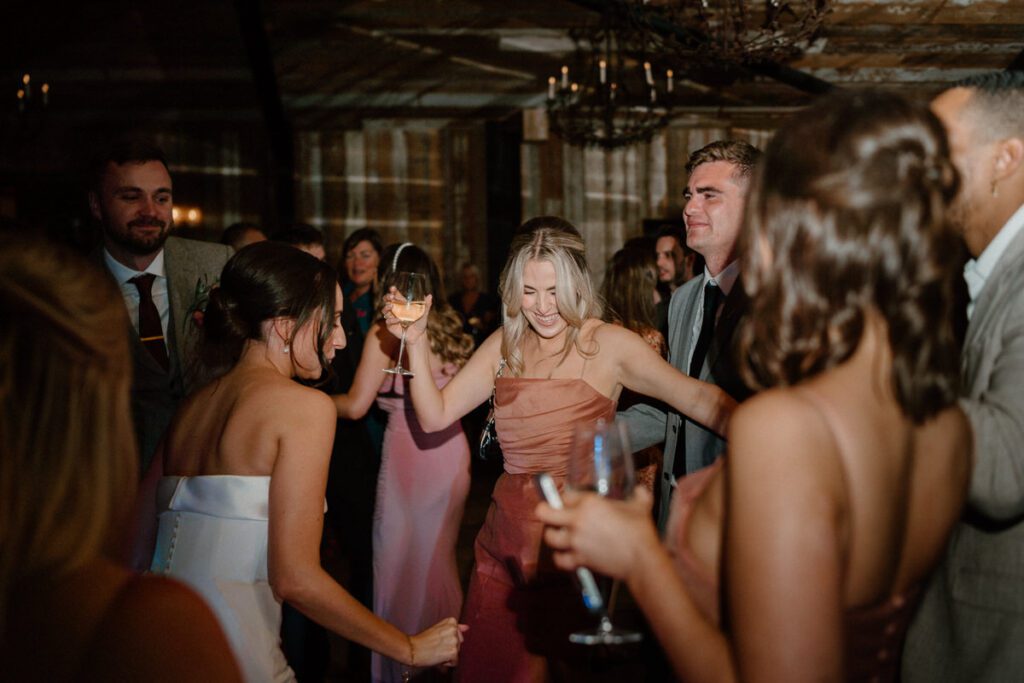 a bride dancing with her guests at her wedding reception at Botley Hill Barn in Surrey