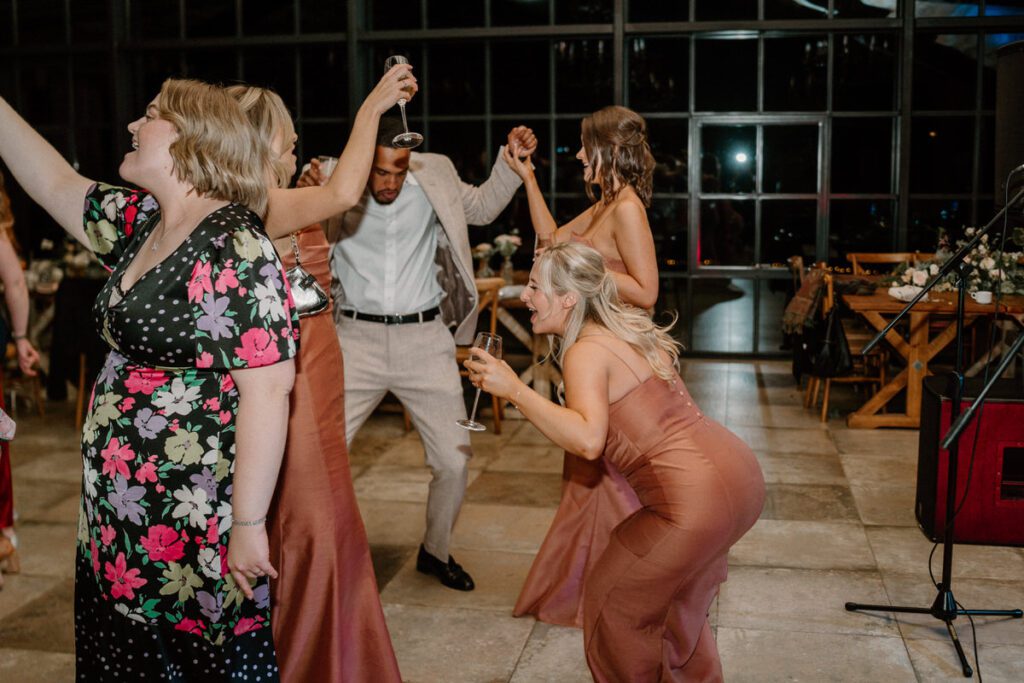 wedding guests dancing on a busy dance floor at a wedding reception party at Botley Hill Barn