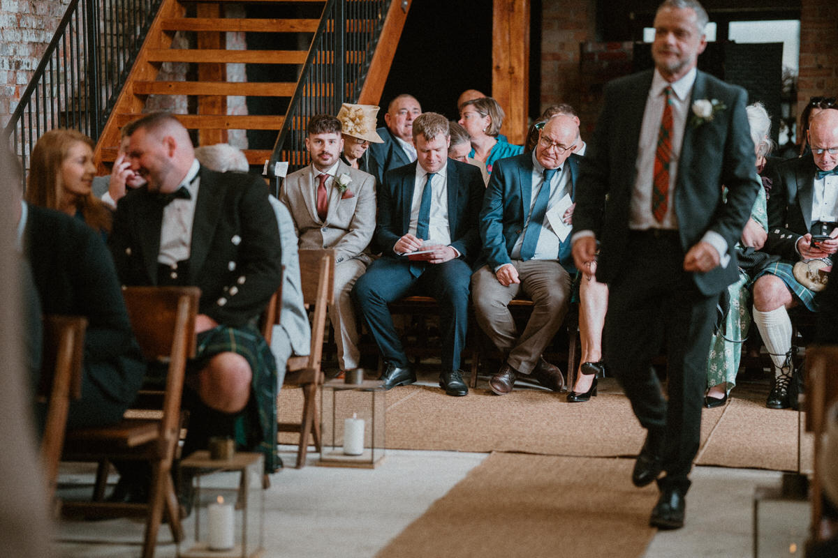 wedding guests sat down waiting for the wedding ceremony to start for a surrey winter wedding