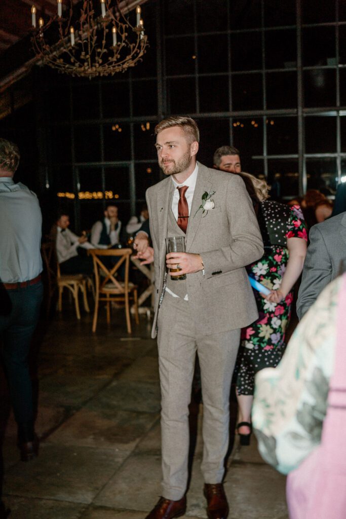 a groom dancing with his wedding guests at Botley Hill Barn