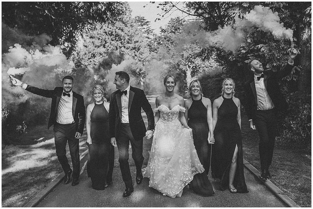 a wedding party with smoke grenades posing and walking